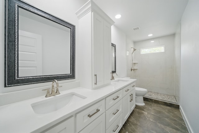 9711 Derrik Dr, Houston, TX 77080 - bathroom featuring a tile shower, double vanity, toilet, and a sink