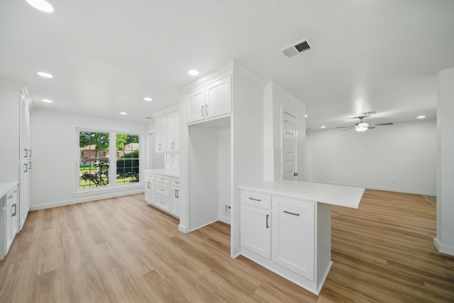 9711 Derrik Dr, Houston, TX 77080 - kitchen featuring light wood-style flooring, visible vents, white cabinetry, a ceiling fan, and light countertops