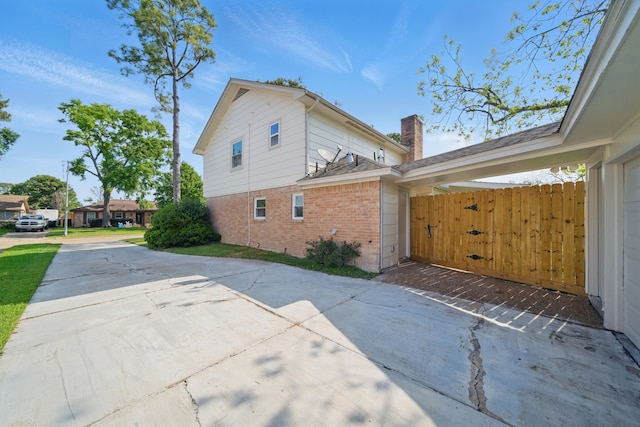 9711 Derrik Dr, Houston, TX 77080 - view of side of property with brick siding, a chimney, and concrete driveway