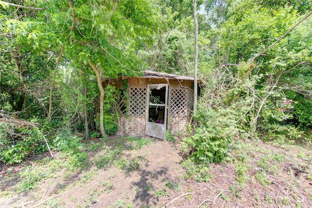 808 State Highway Loop 393, Goodrich, TX 77335 - view of outbuilding with an outbuilding and a wooded view