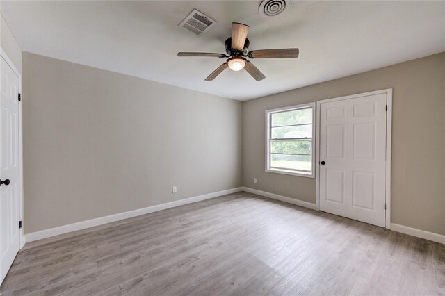808 State Highway Loop 393, Goodrich, TX 77335 - unfurnished bedroom with wood finished floors, baseboards, and a ceiling fan