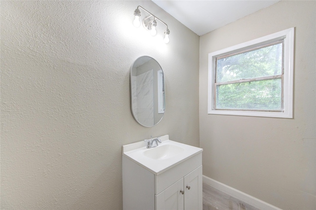 808 State Highway Loop 393, Goodrich, TX 77335 - bathroom with vanity, wood finished floors, and baseboards
