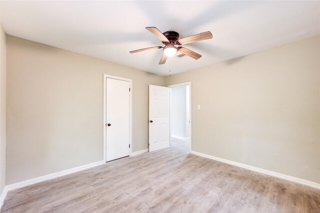 808 State Highway Loop 393, Goodrich, TX 77335 - unfurnished bedroom with light wood-style flooring, baseboards, and a ceiling fan