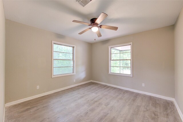 808 State Highway Loop 393, Goodrich, TX 77335 - empty room with plenty of natural light, light wood-style flooring, and baseboards