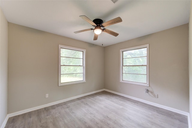 808 State Highway Loop 393, Goodrich, TX 77335 - spare room featuring healthy amount of natural light, wood finished floors, a ceiling fan, and baseboards
