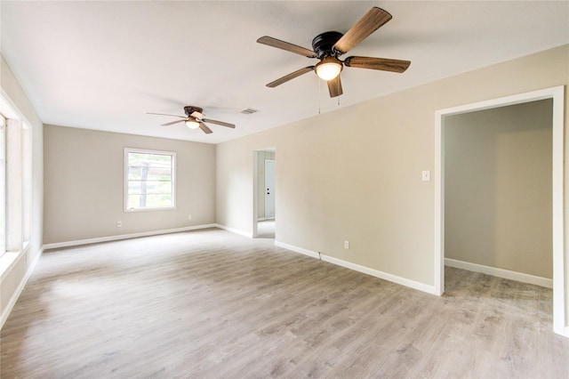 808 State Highway Loop 393, Goodrich, TX 77335 - unfurnished room with a ceiling fan, light wood-style floors, and baseboards