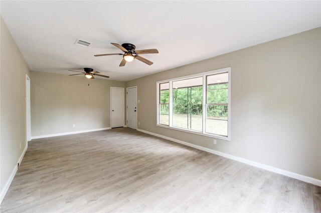 808 State Highway Loop 393, Goodrich, TX 77335 - unfurnished room featuring a ceiling fan, baseboards, and light wood finished floors