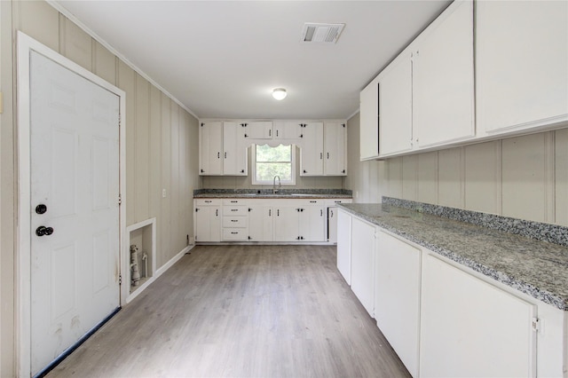 808 State Highway Loop 393, Goodrich, TX 77335 - kitchen with a sink, white cabinetry, and light wood-type flooring