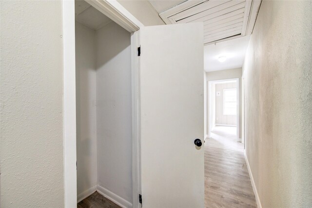 808 State Highway Loop 393, Goodrich, TX 77335 - corridor featuring wood finished floors, baseboards, and a textured wall