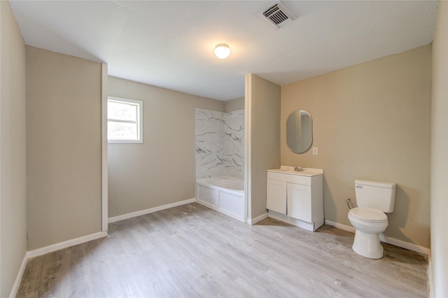 808 State Highway Loop 393, Goodrich, TX 77335 - bathroom with wood finished floors, vanity, a tub to relax in, toilet, and baseboards