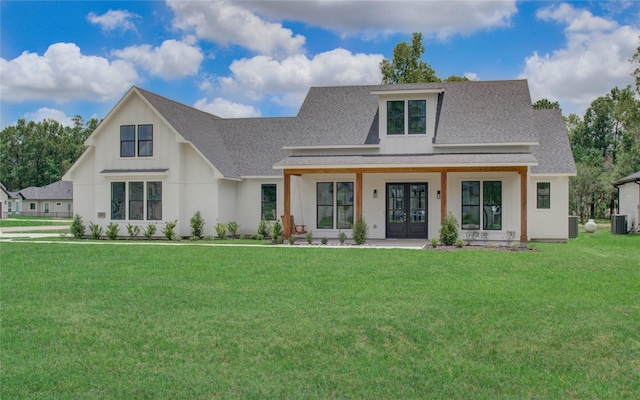 modern farmhouse style home featuring central AC, a front lawn, a shingled roof, and french doors