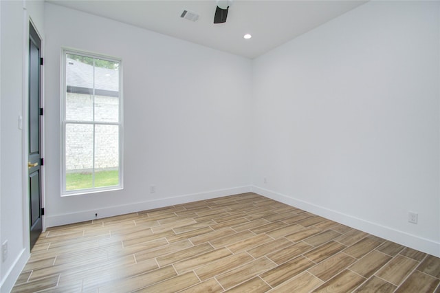 unfurnished room with visible vents, light wood finished floors, baseboards, and ceiling fan