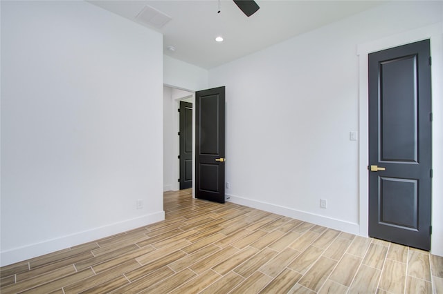 empty room featuring visible vents, ceiling fan, baseboards, and light wood-type flooring