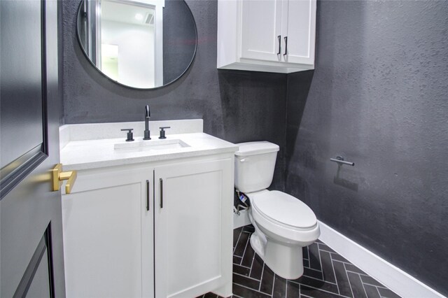 half bathroom with toilet and vanity