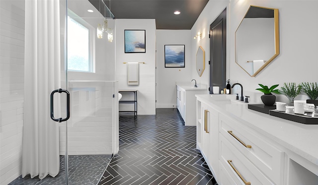 bathroom featuring baseboards, vanity, recessed lighting, and a stall shower