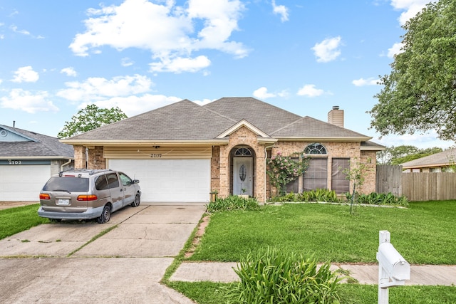 ranch-style house featuring a front lawn, a chimney, concrete driveway, fence, and an attached garage