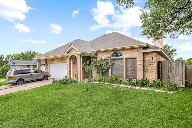 ranch-style house with a chimney, an attached garage, brick siding, and a front lawn