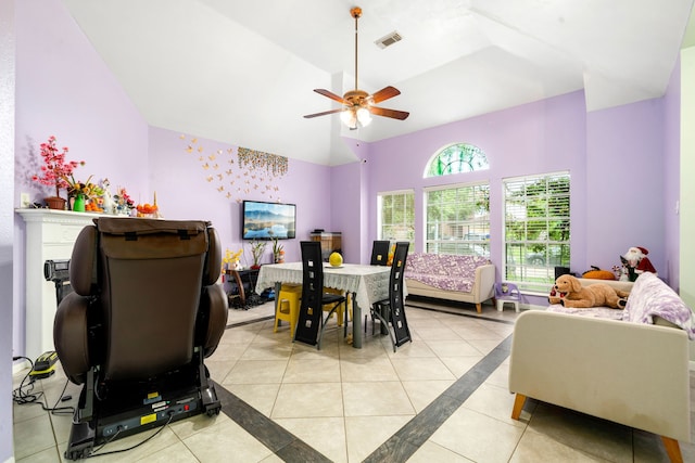 dining space featuring visible vents, a ceiling fan, high vaulted ceiling, and light tile patterned floors