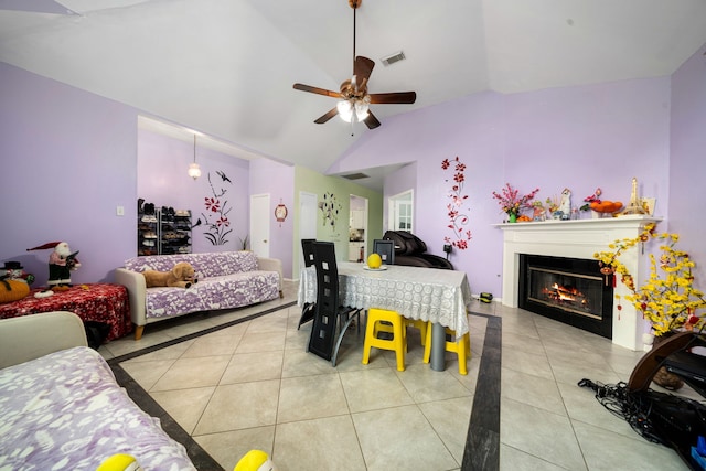 bedroom featuring tile patterned floors, visible vents, a glass covered fireplace, ceiling fan, and high vaulted ceiling