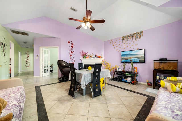 dining room featuring vaulted ceiling, a ceiling fan, visible vents, and light tile patterned floors