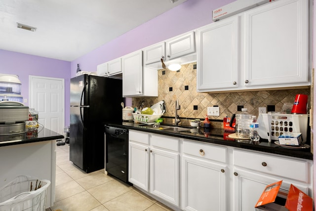 kitchen featuring dark countertops, light tile patterned floors, a sink, black appliances, and tasteful backsplash