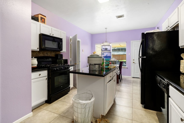 kitchen with white cabinets, dark countertops, visible vents, a center island, and black appliances