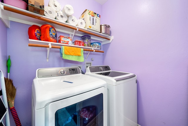 clothes washing area featuring washing machine and dryer and laundry area
