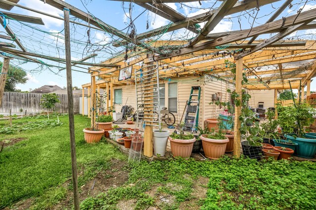 exterior space featuring a pergola, a lawn, and a fenced backyard