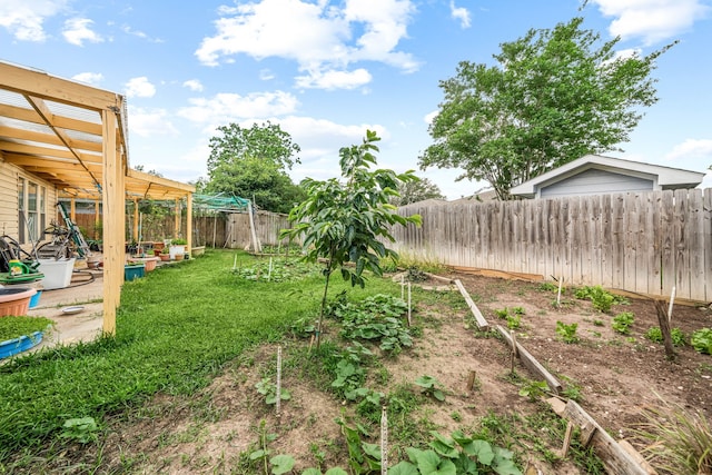 view of yard with a fenced backyard, a pergola, and a vegetable garden