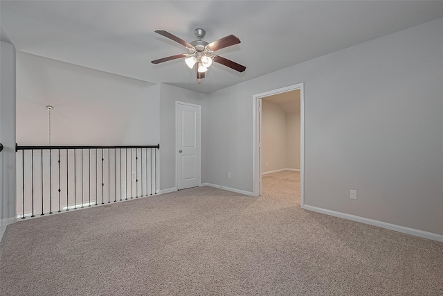 spare room featuring a ceiling fan, baseboards, and carpet floors