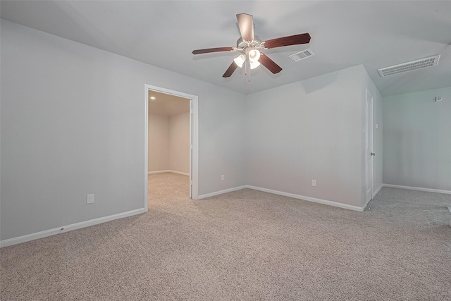 unfurnished room with light colored carpet, ceiling fan, baseboards, and visible vents