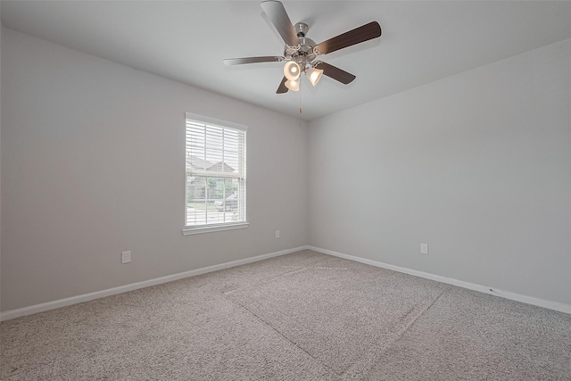 spare room featuring baseboards, carpet flooring, and ceiling fan