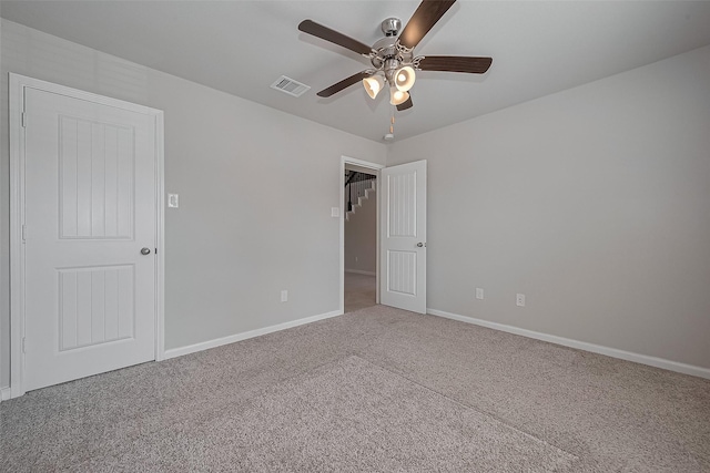 unfurnished bedroom with baseboards, visible vents, carpet floors, and ceiling fan
