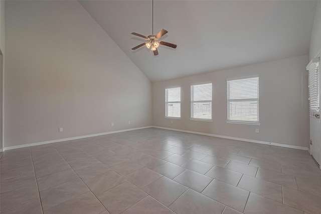 unfurnished room featuring lofted ceiling, baseboards, ceiling fan, and light tile patterned floors