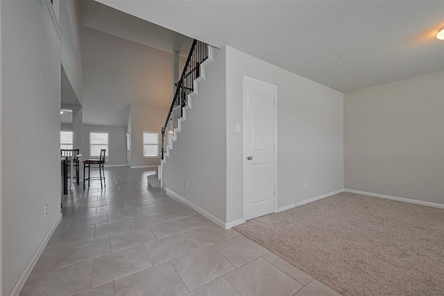 6907 Arcadia Meadow Ct, Richmond, TX 77407 - empty room featuring baseboards, light tile patterned floors, and light carpet