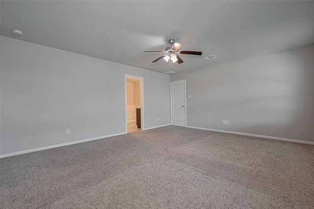 carpeted spare room featuring ceiling fan, baseboards, and visible vents