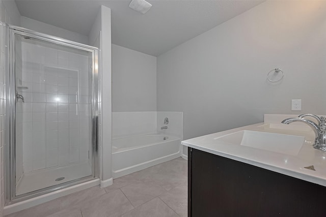 bathroom featuring tile patterned flooring, visible vents, a sink, a garden tub, and a stall shower