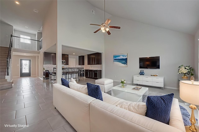 6907 Arcadia Meadow Ct, Richmond, TX 77407 - living room with high vaulted ceiling, ceiling fan, baseboards, light tile patterned floors, and recessed lighting