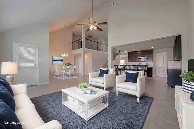 6907 Arcadia Meadow Ct, Richmond, TX 77407 - living area featuring ceiling fan, light tile patterned floors, stairs, high vaulted ceiling, and a chandelier