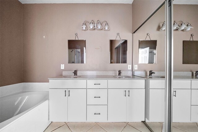 150 N Magnolia Pond Pl, The Woodlands, TX 77381 - full bathroom with double vanity, a garden tub, and tile patterned flooring