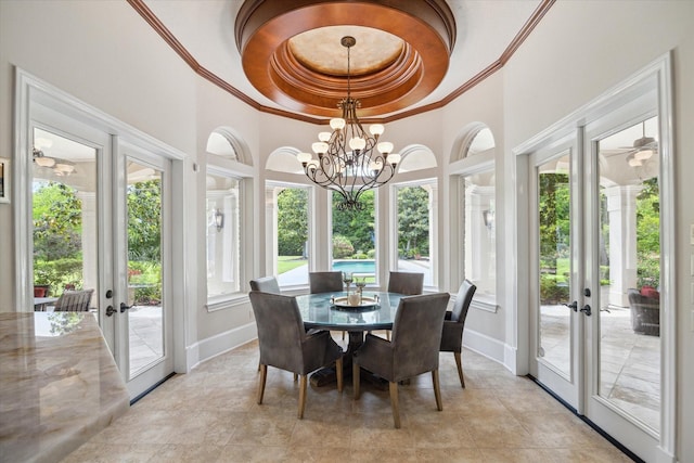 sunroom / solarium featuring a notable chandelier and french doors