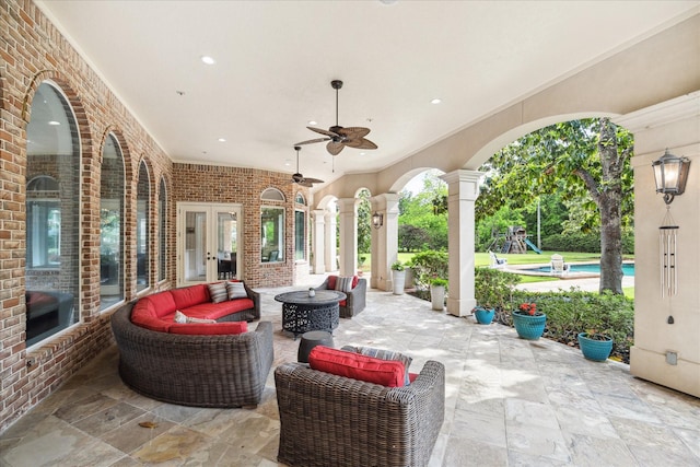 view of patio with a ceiling fan, outdoor lounge area, an outdoor pool, and french doors