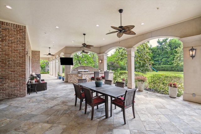 view of patio featuring area for grilling, ceiling fan, and outdoor dining space