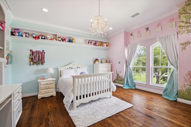 bedroom with visible vents, ornamental molding, wood finished floors, and a chandelier