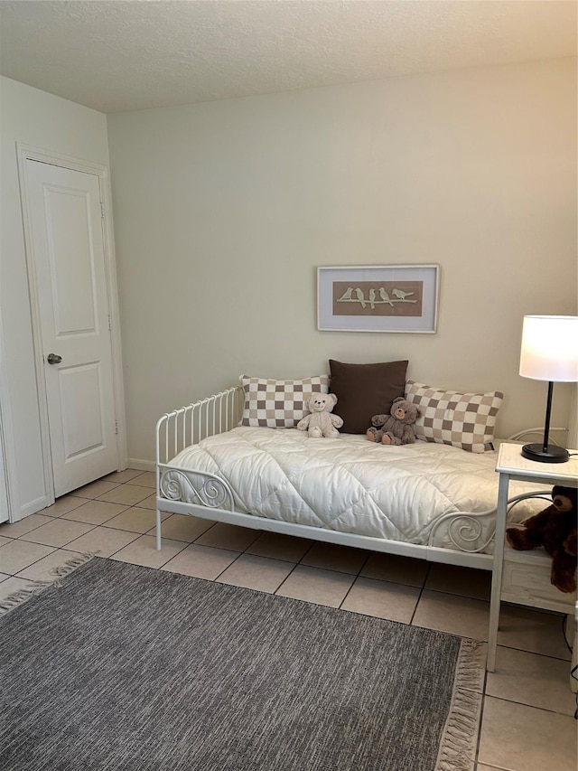 bedroom featuring light tile patterned floors