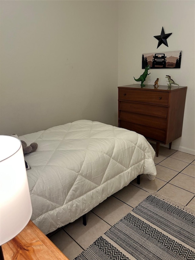 bedroom with light tile patterned floors