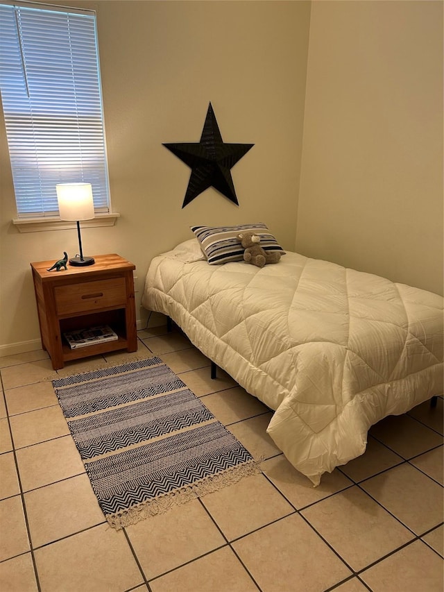 bedroom featuring baseboards and tile patterned floors