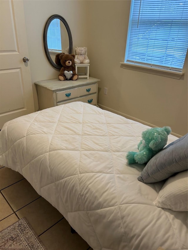 tiled bedroom with multiple windows