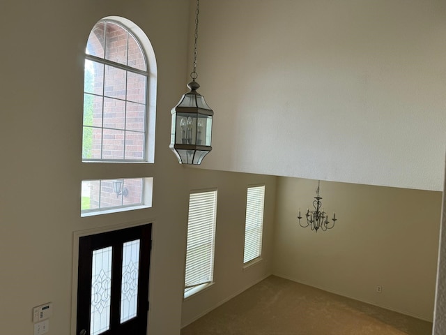 4923 Lake Gladewater Ct, Richmond, TX 77407 - carpeted foyer entrance with a chandelier, healthy amount of natural light, a high ceiling, and baseboards