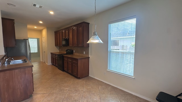 4923 Lake Gladewater Ct, Richmond, TX 77407 - kitchen with black appliances, a sink, light tile patterned floors, baseboards, and recessed lighting